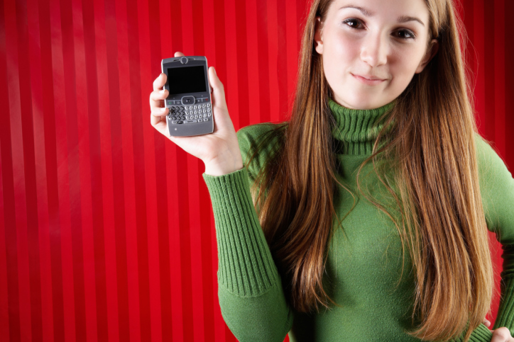 Smiling woman posing with smartphone