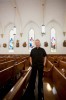 Priest standing in church pews